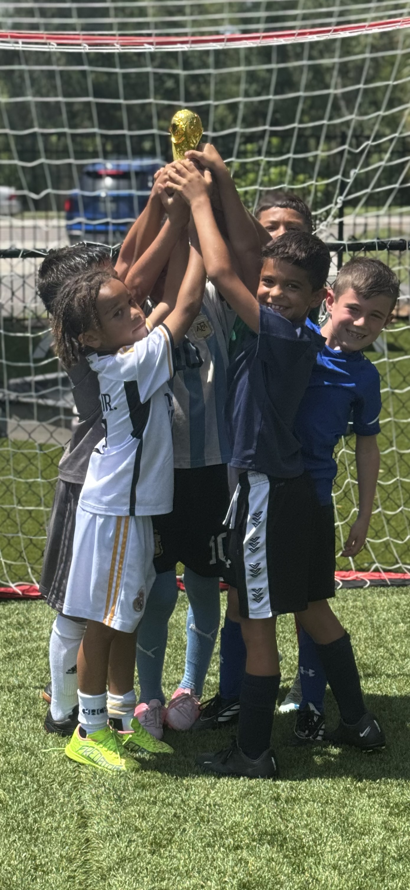 Kids celebrating with trophy